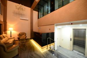 a lobby with two chairs and a door and a building at Hotel Aristocrat Batumi in Batumi