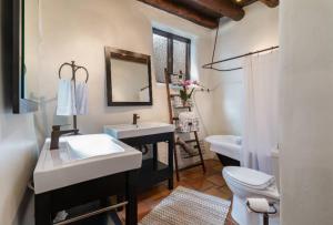 a bathroom with a sink and a toilet and a mirror at Inn of the Turquoise Bear in Santa Fe +68 photos