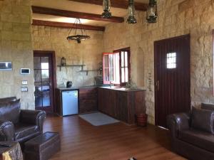 a room with a kitchen and a living room at Jasmin Holiday House in Alexandria