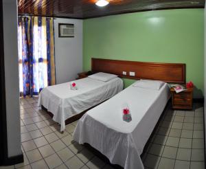 Postel nebo postele na pokoji v ubytování Rede Andrade Estrela Dalva Centro Hotel