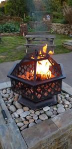 a fire pit in a yard with a picnic table at Devonshire Arms Inn in Cracoe