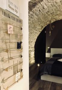 a bedroom with a wall with a sign that reads follow your dreams at L'ArChasetta Historic Apartments in Casamassima