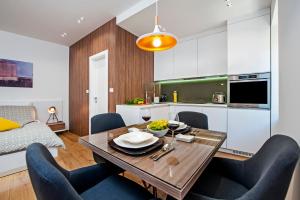 a kitchen and dining room with a table and chairs at Apartments Vincero in Rovinj