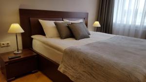 Posteľ alebo postele v izbe v ubytovaní Soprano Apartment Tamanska