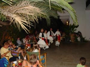 a group of people performing a dance at a party at Ipsos Beach Hotel in Ipsos