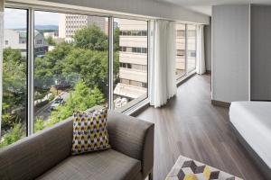 a living room with a couch and large windows at Hyatt Regency - Greenville in Greenville