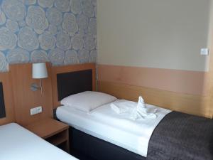 Postel nebo postele na pokoji v ubytování Hotel Rozvoj