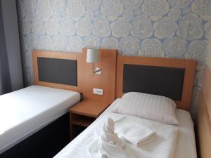 Postel nebo postele na pokoji v ubytování Hotel Rozvoj