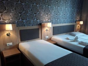 Postel nebo postele na pokoji v ubytování Hotel Rozvoj