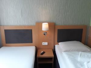 Postel nebo postele na pokoji v ubytování Hotel Rozvoj