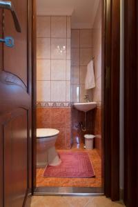 a bathroom with a toilet and a sink at Hajdu Apartman 2. in Hajdúszoboszló +10 photos