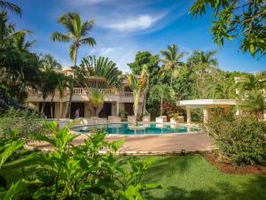a resort with a swimming pool and palm trees at Villa La Plantacion in Las Galeras
