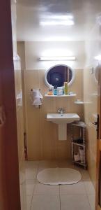 a bathroom with a sink and a mirror at Douja Apartment in Nabeul