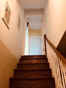 a stairway with a white door in a house at Seaview White House in Stratford