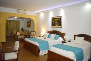 Ένα ή περισσότερα κρεβάτια σε δωμάτιο στο El Gran Hotel de Pereira