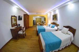 Ένα ή περισσότερα κρεβάτια σε δωμάτιο στο El Gran Hotel de Pereira
