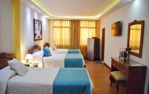 Ένα ή περισσότερα κρεβάτια σε δωμάτιο στο El Gran Hotel de Pereira