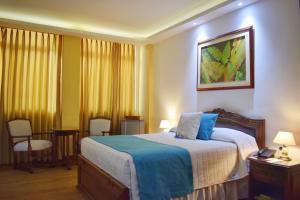 Ένα ή περισσότερα κρεβάτια σε δωμάτιο στο El Gran Hotel de Pereira