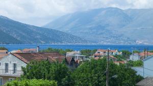 a town with a lake and mountains in the background at Muses Studios Sami in Sami
