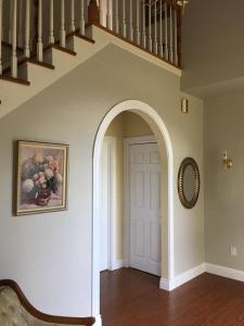 an archway leading to a white door in a house at Seaview White House in Stratford