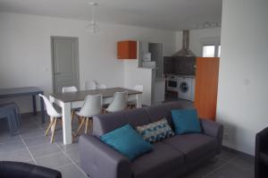 a living room with a couch and a table at La Maison Oceane in Dolus-d'Oléron