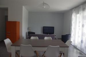 a dining room with a table and chairs at La Maison Oceane in Dolus d'Oléron