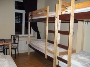 a room with two bunk beds and a table at Hostel No 5 in Halle an der Saale