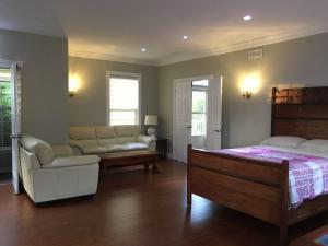 a bedroom with a bed and a couch and a table at Seaview White House in Stratford