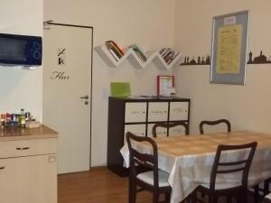 a dining room with a table and chairs and a cabinet at Hostel No 5 in Halle an der Saale