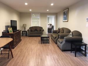 a living room with two couches and a television at Seaview White House in Stratford