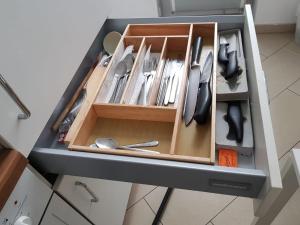 a cabinet filled with utensils in a kitchen at Apartment Dahlia Vienna in Vienna