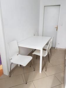 a white table and chairs in a room at Apartment Dahlia Vienna in Vienna