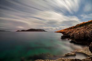 a large body of water next to a rocky shore at Nur Hotel in Kaş
