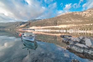 a boat sitting in the water on a lake at Nur Hotel in Kaş