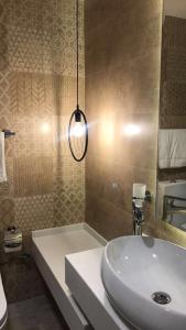 a bathroom with a white sink and a shower at قولدن سكوير طريق الرياض Golden Square Riyadh Road in Khamis Mushayt