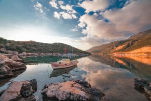 a boat is docked in the water on a river at Nur Hotel in Kaş