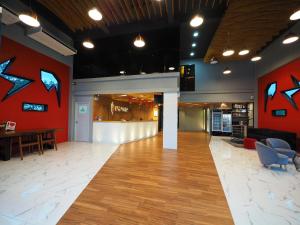 a large lobby with red walls and wooden floors at Ps Sriphu Hotel in Hat Yai