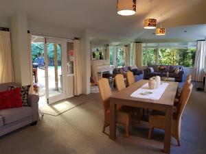a dining room and living room with a table and chairs at Centennial House Taupo in Taupo