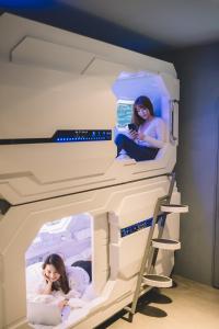 two girls in a bunk bed in a room at Space Hotel @ Chinatown Kuala Lumpur in Kuala Lumpur