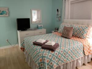 a bedroom with a bed with towels on it at Hilton Head Resort in Hilton Head Island +37 photos