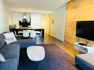 a living room with a couch and a flat screen tv at East 302 St Falls in Falls Creek