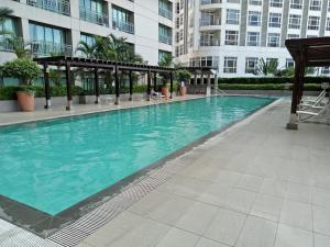 a large swimming pool in a building with a building at N place at Soho Central in Manila