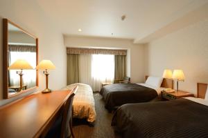 En eller flere senge i et værelse på Hotel Concorde Hamamatsu