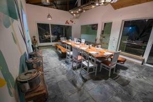 a large dining room with a long table and chairs at Seclude Ramgarh Cliff's edge in Rāmgarh