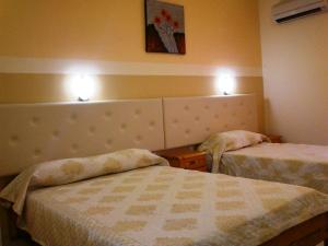 A bed or beds in a room at Summer Memories Aparthotel
