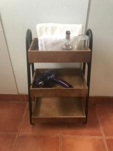 a wooden shelf with a hair dryer on it at Gateway International Motel in Rotorua