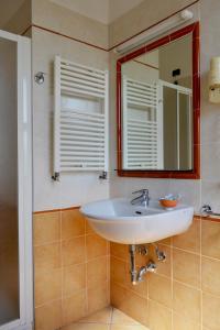 ein Bad mit einem Waschbecken und einem Spiegel in der Unterkunft Hotel Fontana in Rubiera