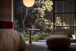a table and a lamp in a room with a window at Hotel Koo Otsuhyakucho in Otsu +56 photos