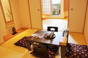 a living room with a table and a chair at harper house in Osaka