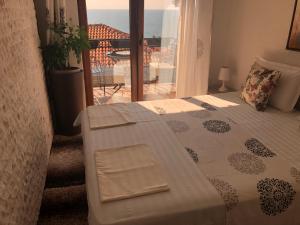 a bedroom with a bed with a view of the ocean at Apartments Debora in Ulcinj